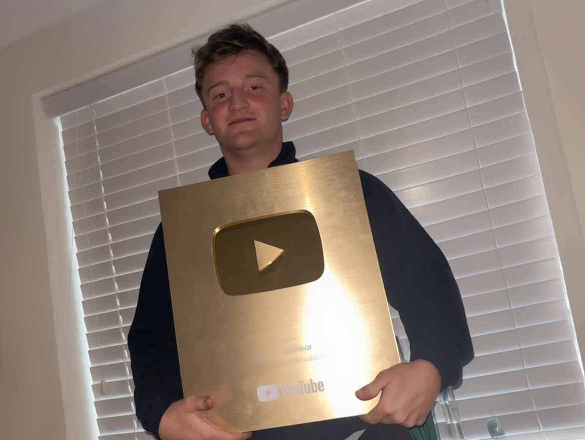 Jake Hughes holding YouTube Gold Play Button